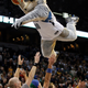 Minnesota Timberwolves mascot Crunch dunks the ball over his spotters during halftime of the Timberwolves' NBA basketball game against the Los Angeles Lakers in the Target Center in Minneapolis.